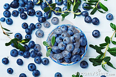 Blueberry or great bilberry in bowl on blue wooden table top view. Organic superfood and healthy nutrition. Stock Photo