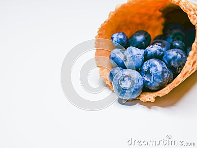 Blueberry Ice Cream. on a white background. blueberries pour from the horn. ice cream isolated on white background Stock Photo