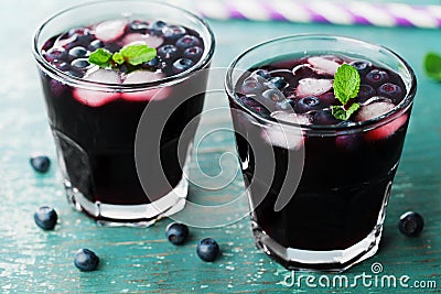 Blueberry lemonade or cocktail on teal rustic table, summer berry juice Stock Photo