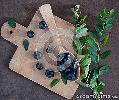 Blueberry and mint, wooden spoon and board top view Stock Photo