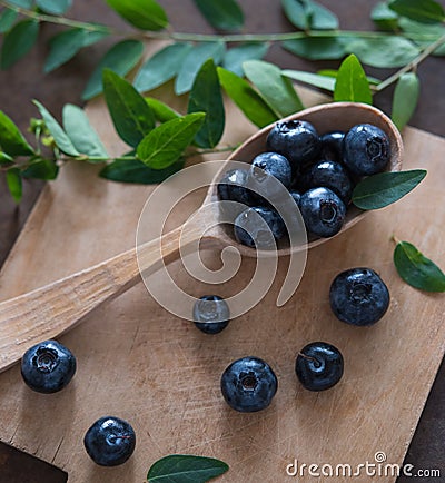 Blueberry and mint, wooden spoon and board top view summer rustic fresh vegan Stock Photo