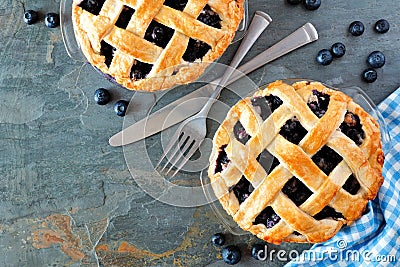 Blueberry pies, top view corner border over a dark background Stock Photo