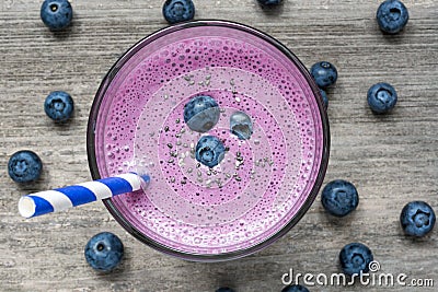 Blueberry smoothie or milkshake with chia seeds, fresh berries and stripped straw Stock Photo