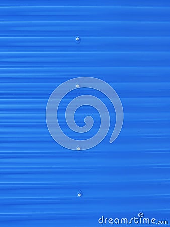 Blueish metallic corrugated sheet roof texture. Deep blue profiled sheet panel. Corrugated Metal Roof Exterior Close up Stock Photo