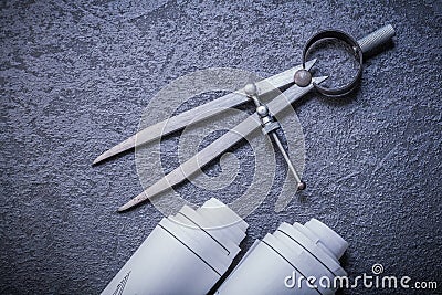 Blueprint rolls pair of compasses on black Stock Photo