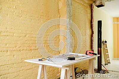 Blueprints, ear defenders, protection glasses and tools on architect workspace at construction site Stock Photo