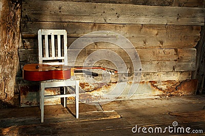 Blues guitar on a white chair with a wooden backgr Stock Photo