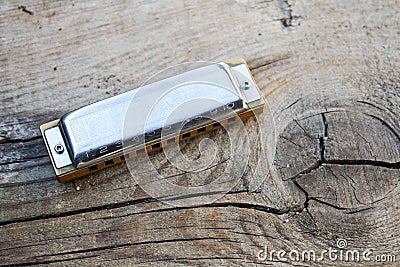 Blues harmonica music instrument on a old wood background Editorial Stock Photo