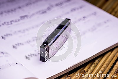 Blues harmonica with notes Stock Photo