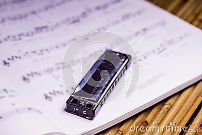 Blues harmonica with notes Stock Photo