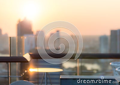 Blur abstract background city morning gold light sky rooftop view over cityscape with bright sun flare and bokeh Stock Photo