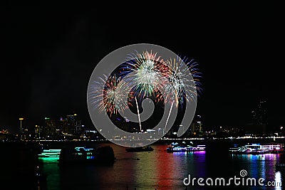 blur green red gold fireworks on beach and reflection color on water surface Stock Photo