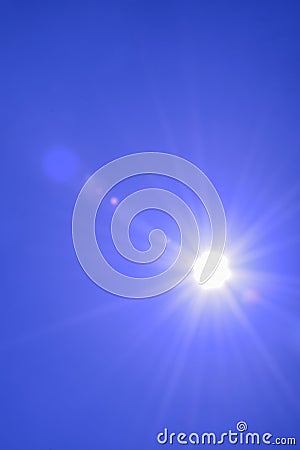 Blur image of a Beautiful morning Sun shines in blue sky.sunburst with Lens flare light over black background Stock Photo