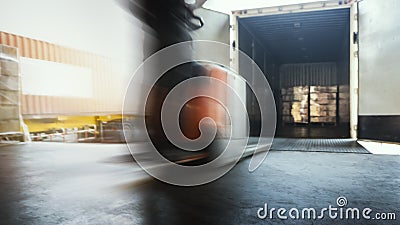 Blur Motion of Workers Driving Forklift Unloading Cargo Pallets into Container Trucks. Shipping Warehouse. Delivery Service Stock Photo