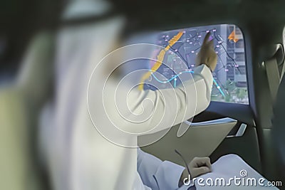 Blur photo - abstract image for the background. A man is an Arab, in an interactive taxi car, plots a route on a map. Stock Photo