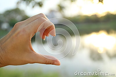 Blur photo of one hand show half of heart Stock Photo