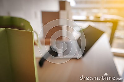 Blur picture of green shopping paper bag with laptop Stock Photo