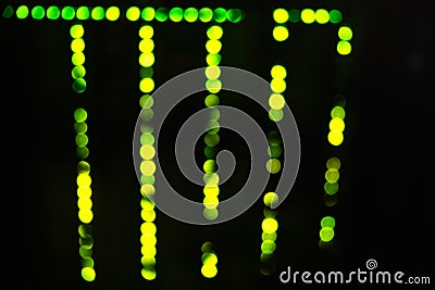 Blurred abstract background of green server lights, bokeh lamps in a row Stock Photo