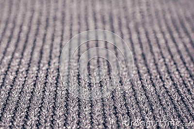Blurred abstract background of grey knitted fabric made of silvery yarn. Stock Photo