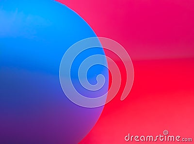 Blurred abstract photo with half blue sphere/ball on red/pink background Stock Photo