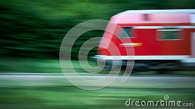 Blurred Abstract Photo of a Speeding Red Train with Foliage Background Stock Photo