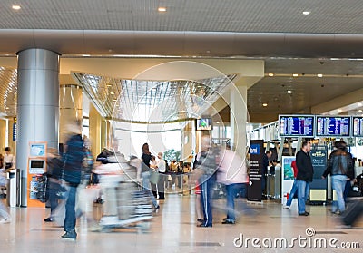 Blurred advancing people in airport installations Stock Photo