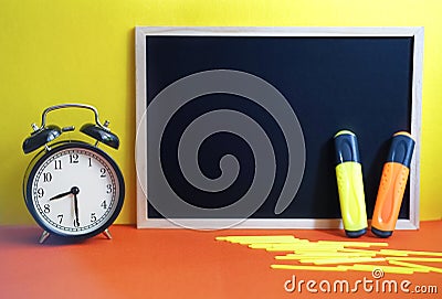 Blurred Back to school concept. Stationery colorful, alarm clock. Stock Photo