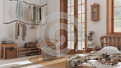 Blurred background, boho chic farmhouse bedroom with rattan bed, rustic walk in closet and armchair. Jute carpet. Vintage Stock Photo
