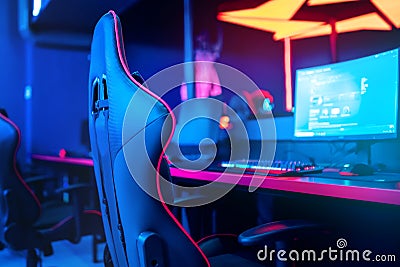 Blurred background computer pc, keyboard armchair, blue and red lights. Concept online eSports arena for gamer playing Stock Photo