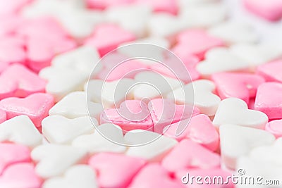 Blurred background for Valentines day charity romantic concept from white and pink sugar candy hearts. Girls baby shower birthday Stock Photo