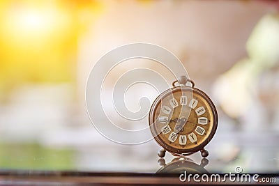The blurred background of a vintage-style clock resting on the back of a piano in the music practice room is a collection of alarm Stock Photo