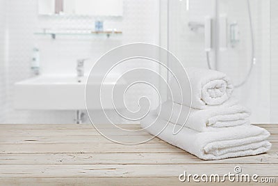 Blurred bathroom interior background and white spa towels on wood Stock Photo