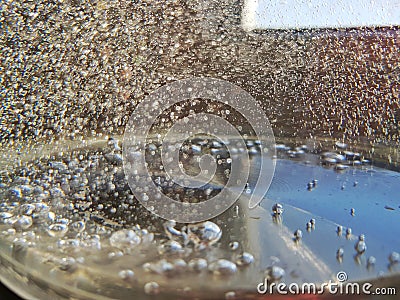 Air bubbles in the fresh boiling water with bokeh blur Stock Photo