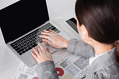 Blurred businesswoman using laptop with blank Stock Photo