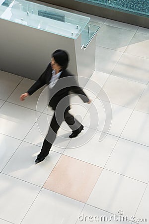 Blurred businesswoman walking Stock Photo