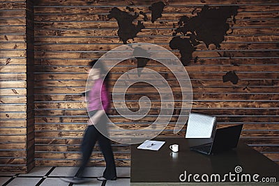Blurred businesswoman walking to her desk Stock Photo