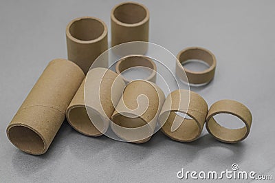 Blurred cardboard spools for winding. Reels made of cardboard. Background of cardboard bobbins. Selective focus Stock Photo