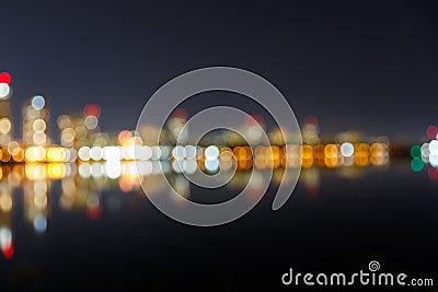 Dark cityscape with illuminated buildings and Stock Photo