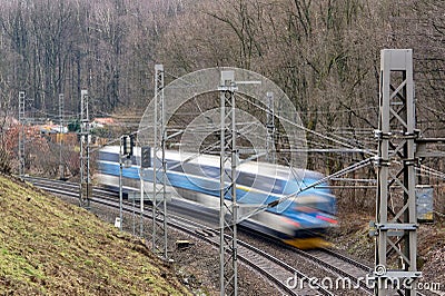 Blurred fast driving Czech train with railroad using motion blur effect Stock Photo