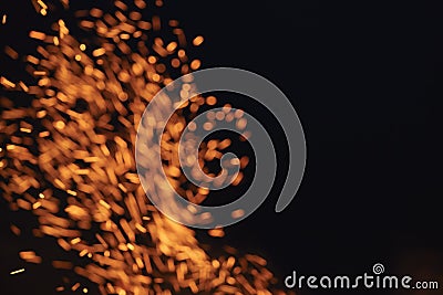 Blurred firecamp sparks over night sky Stock Photo