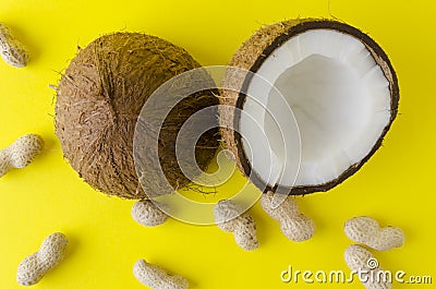 Coconut, peanuts, kiwi fruit on yellow brigh surface -concept of traveling, vacation at the exotic countries Stock Photo