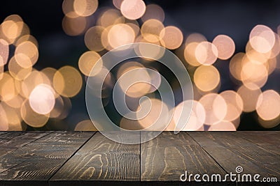 Blurred gold garland and wooden tabletop as foreground. Image for display your christmas products Stock Photo