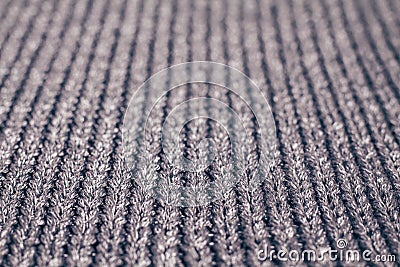 Blurred grey knitted fabric made of silvery yarn textured background. Stock Photo