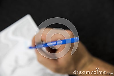 Blurred hand handling a blue pencil colouring Stock Photo