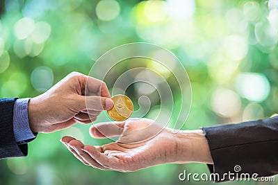 Blurred Hands of two businessmen are trading coin of ethereum. A symbolic coins of ethereum. electronic money exchange, Editorial Stock Photo