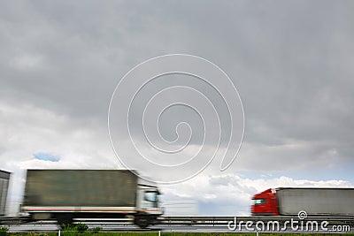 Blurred heavy trucks on highway Stock Photo