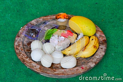 Blurred image, Bengali sweets, banana , mango etc. materials to be offered for worshipping lord Jagannath is arranged and placed Stock Photo