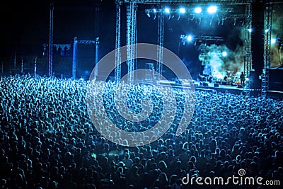 Blurred Image of Huge Crow of People at Music concert, in blue t Stock Photo