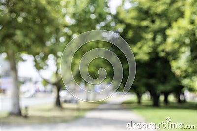 Blurred image of park outdoors walking path pedestrian background backdrop urban green scene out of focus shot defocused picture Stock Photo