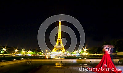 Blurred Image, Romantic eiffel tower in paris with blurred couple ask marry in background, France by night, Eiffel Tower with Editorial Stock Photo